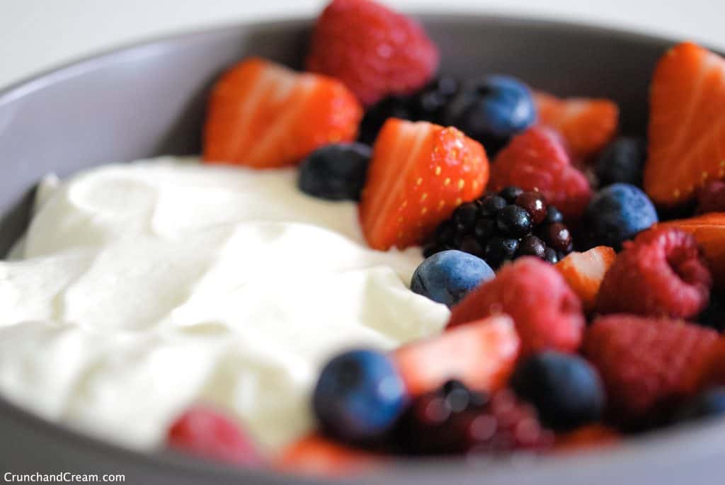 eye-level of a bowl with berries on the left and cheesecake mixture on the right