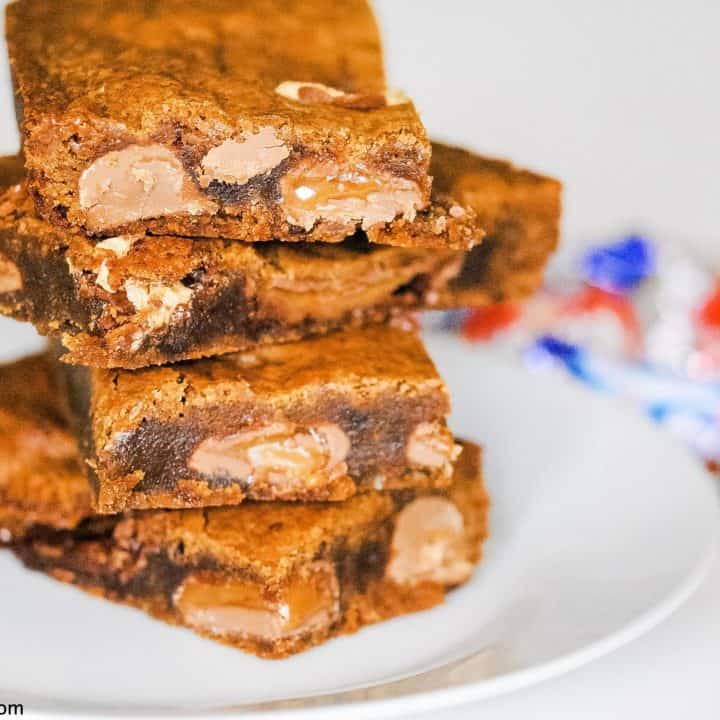 blondies stuffed with chocolate bars piled up on a plate